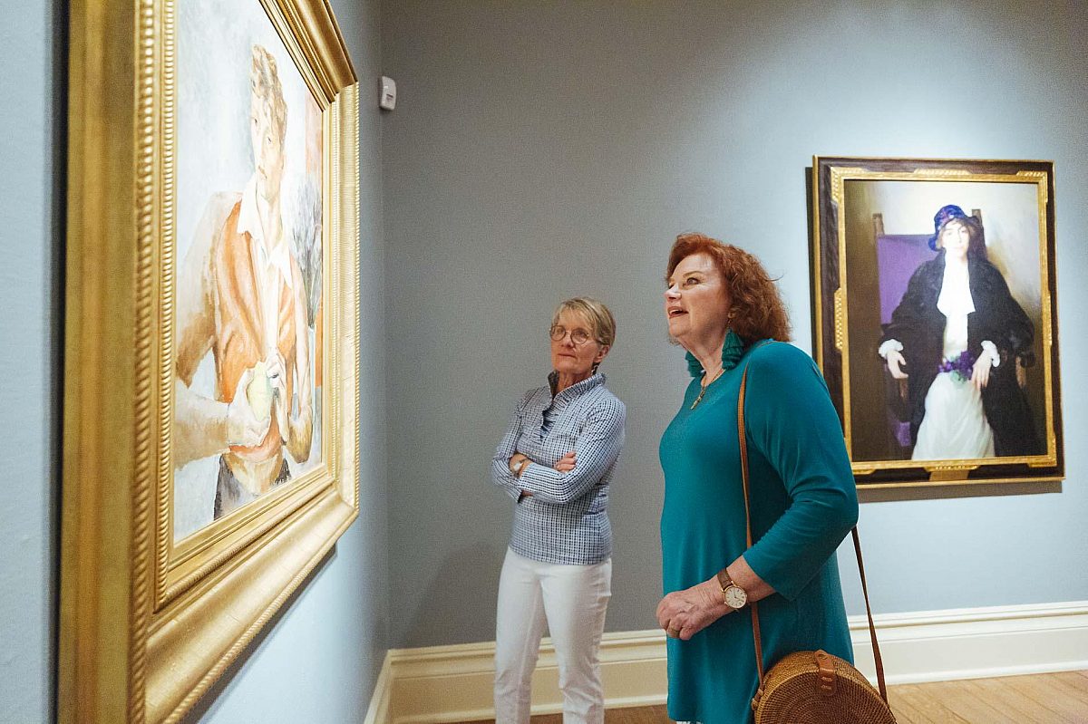 Two women looking at a painting in the Dixon galleries