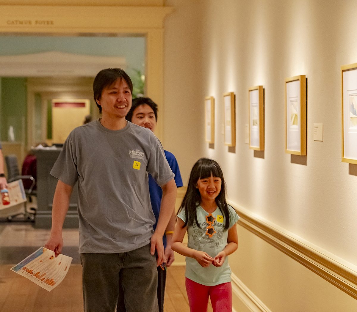 family walking through the galleries viewing artwork