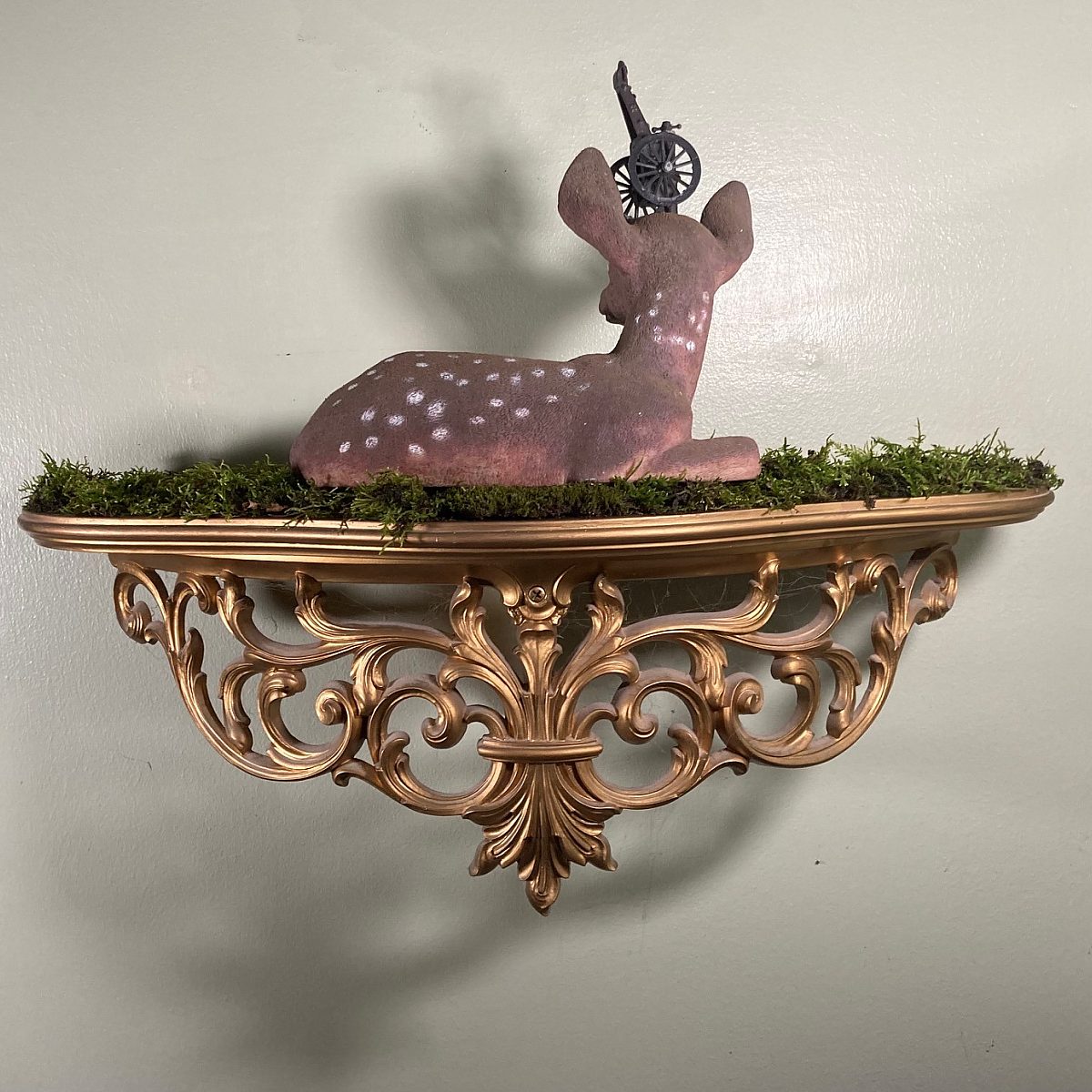 J Clay (Joseph Lee Clayton), "TBMC (Trauma Based Mind Control)," 2024; Plastic deer, cannon pencil sharpener, found moss from forest, and resin shelf; Courtesy of the artist