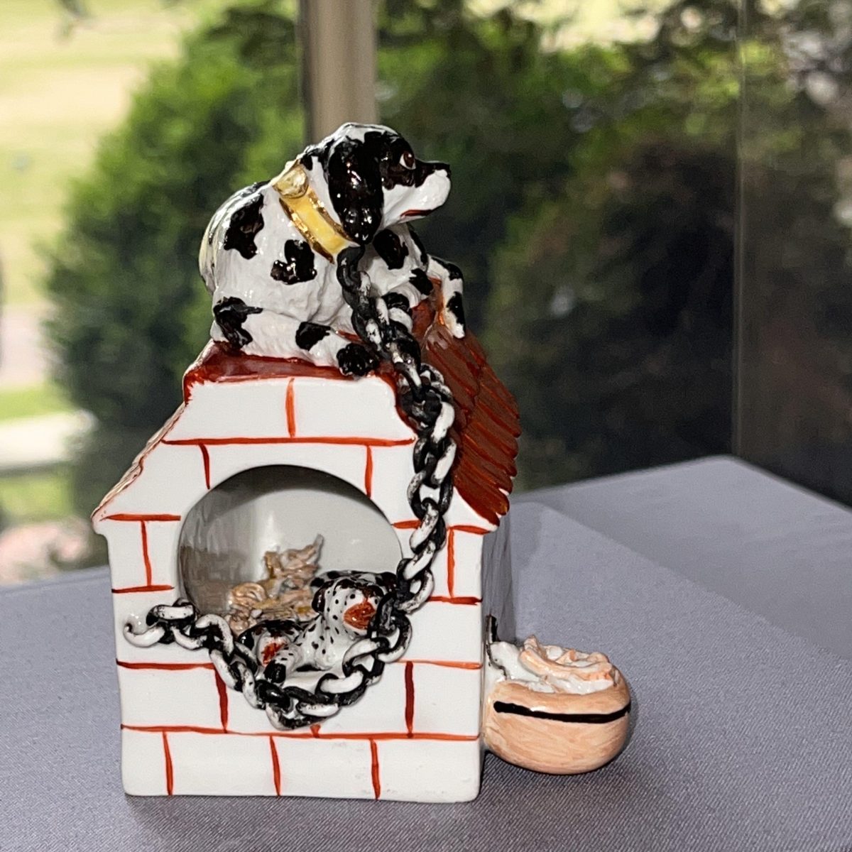 Kennel with Mother and Puppies with chain connected to kennel