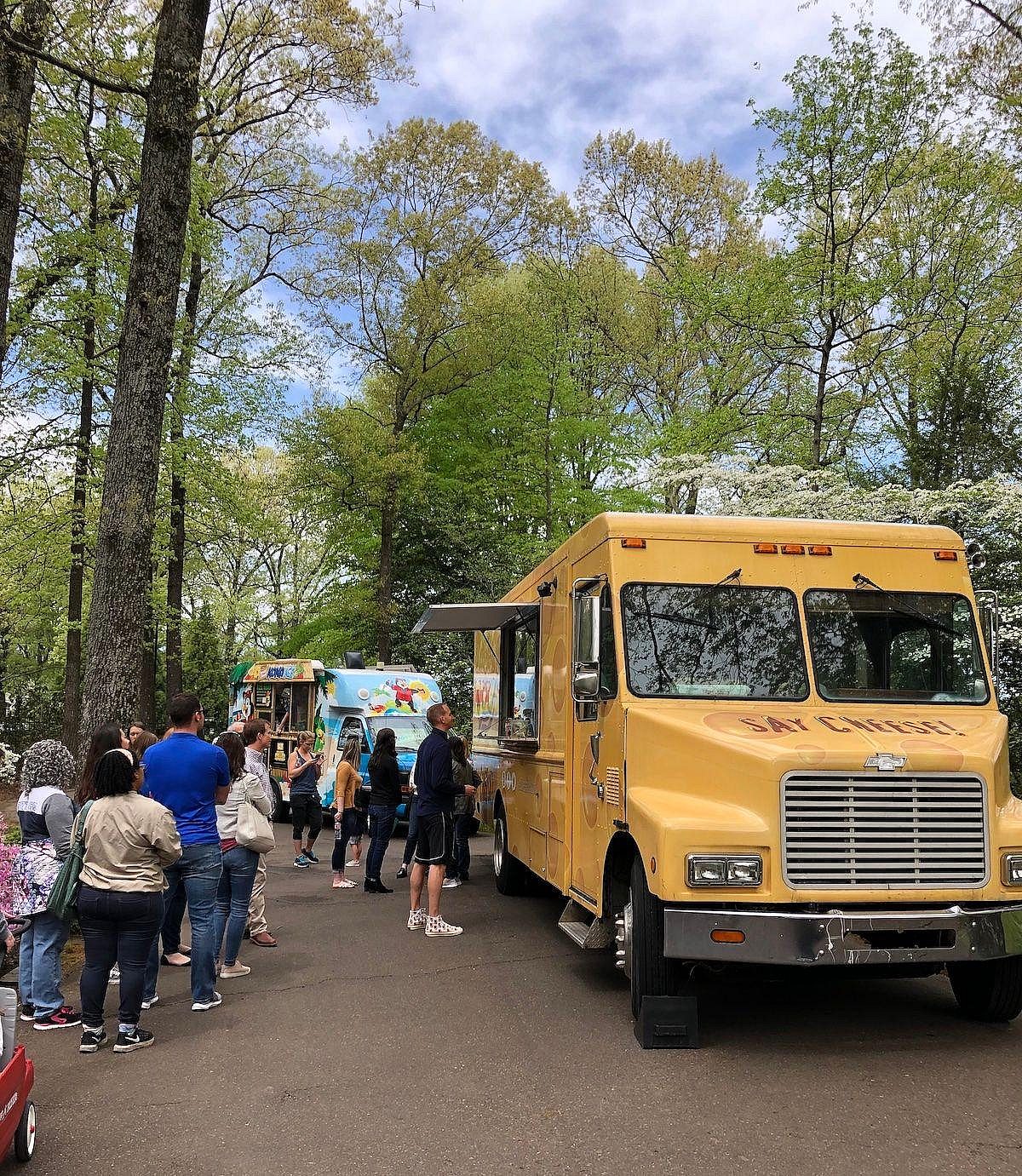 People standing in line at the food trucks