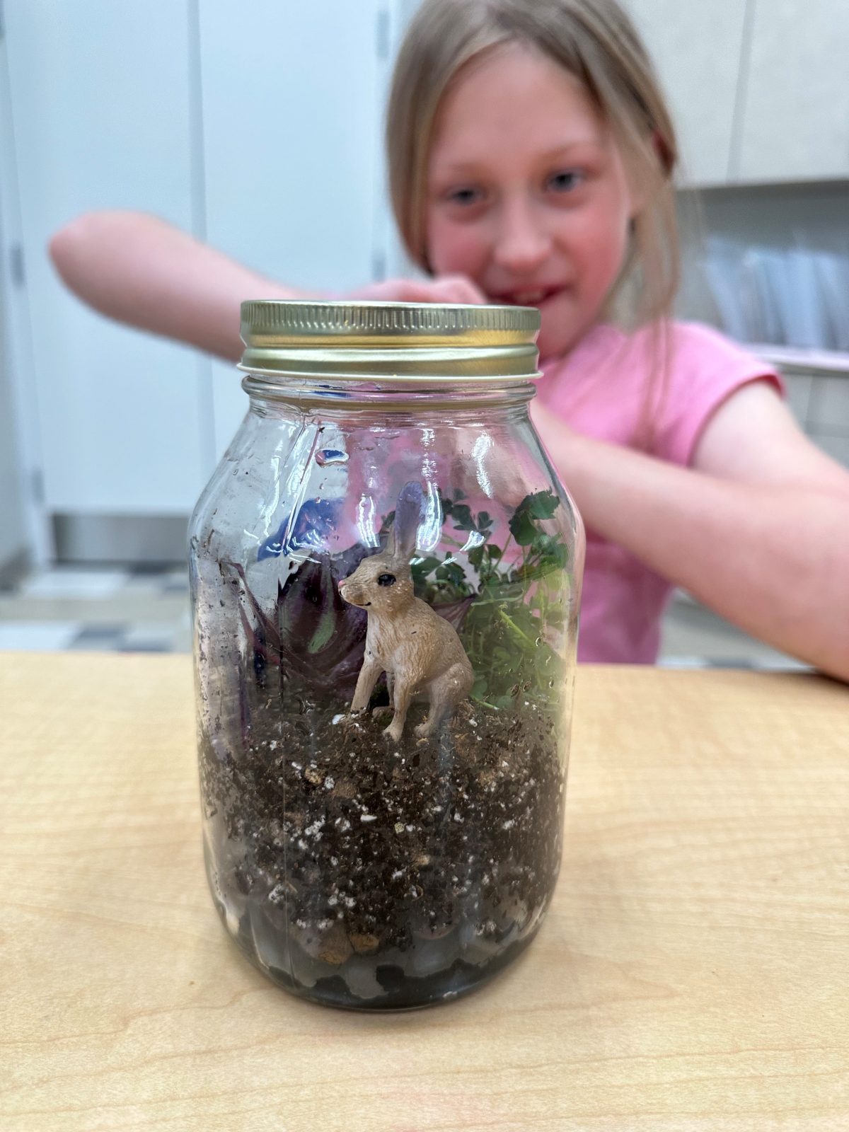 students behind craft in a jar
