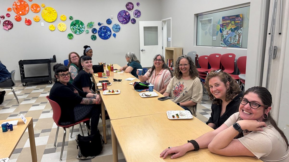 a group of teachers sitting at a table