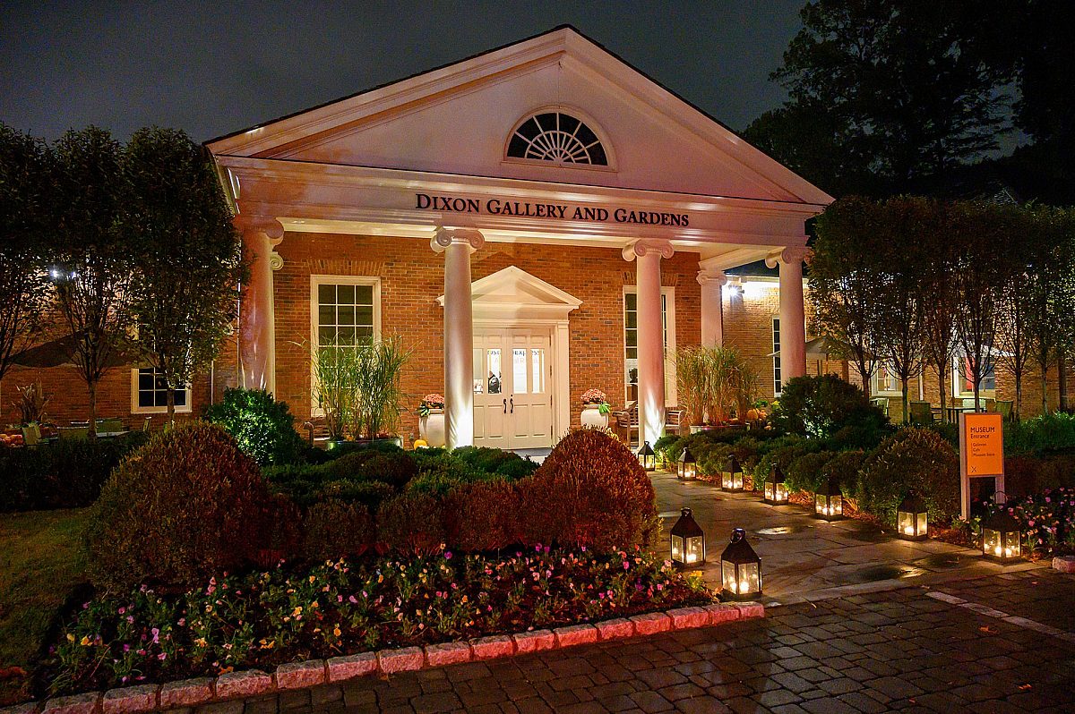 the museum's entrance at night, lit by lanterns lining the walkway