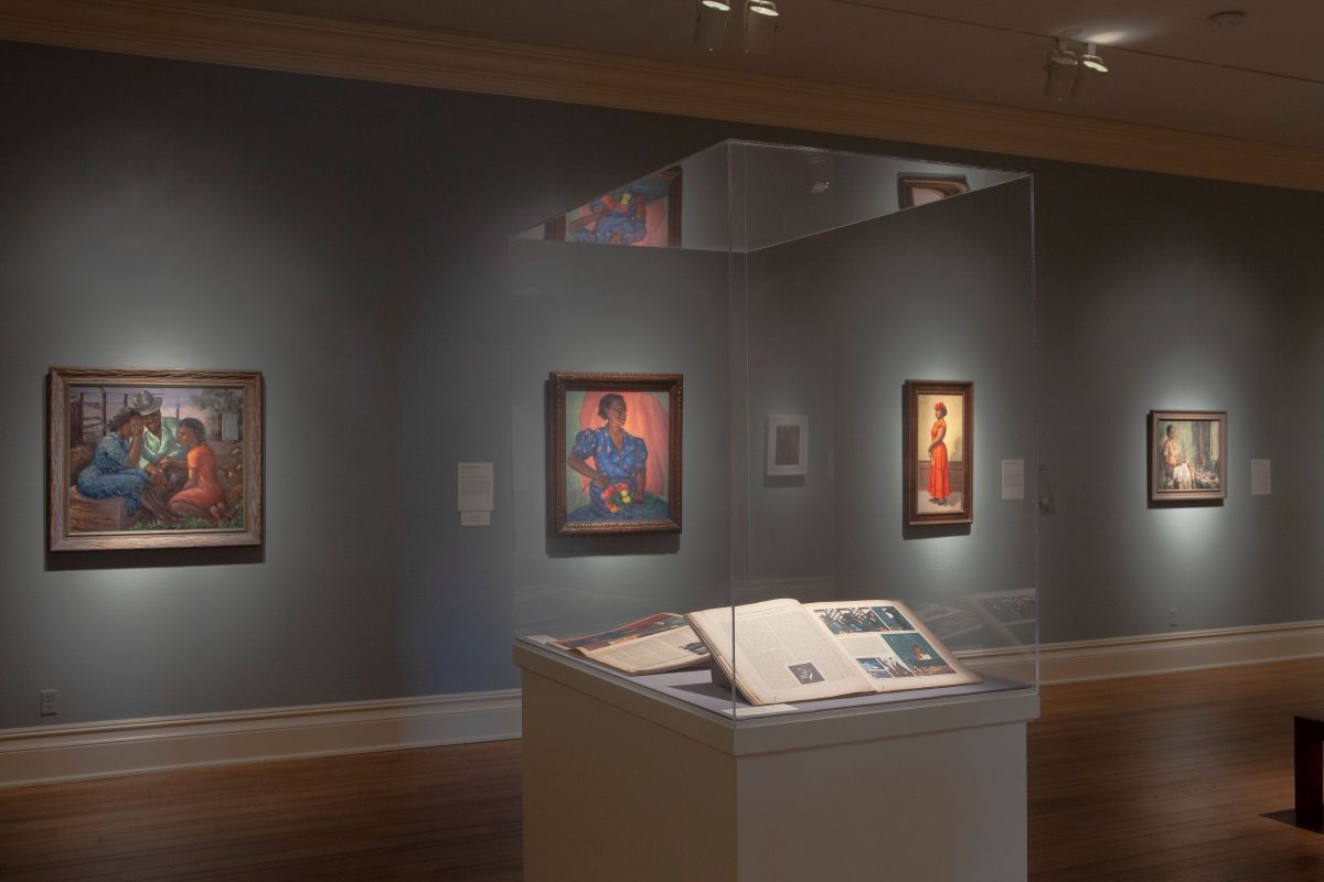 gallery of paintings and display case of books