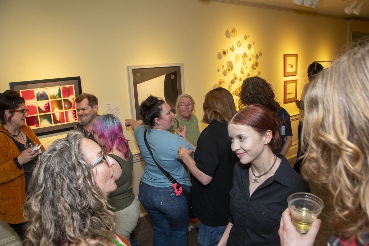 several people enjoying art reception