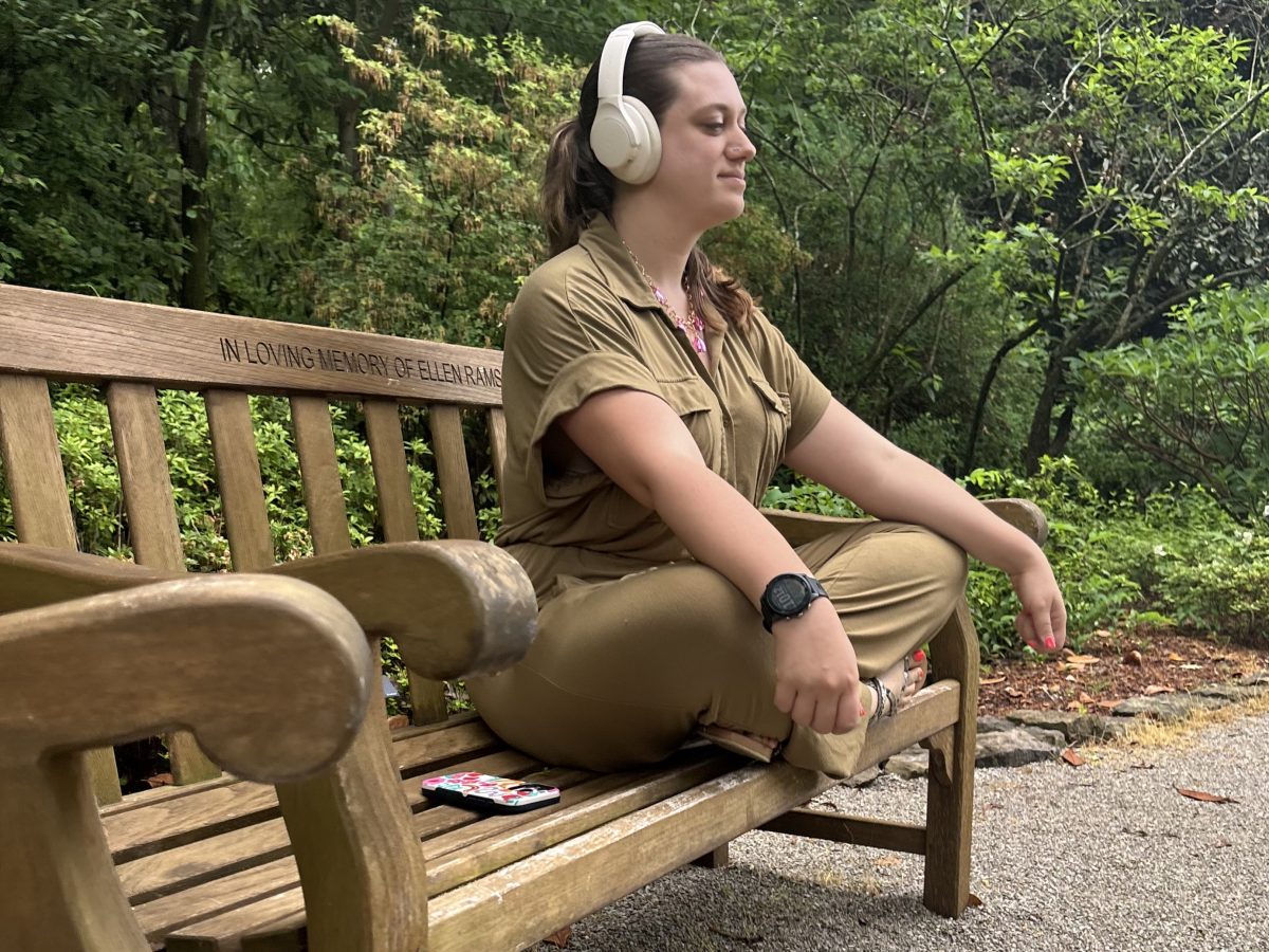 Woman sitting on bench listening to the guided meditations