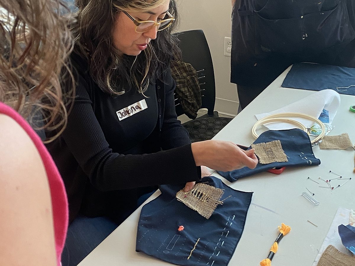 Workshop participant learning how to embrioder
