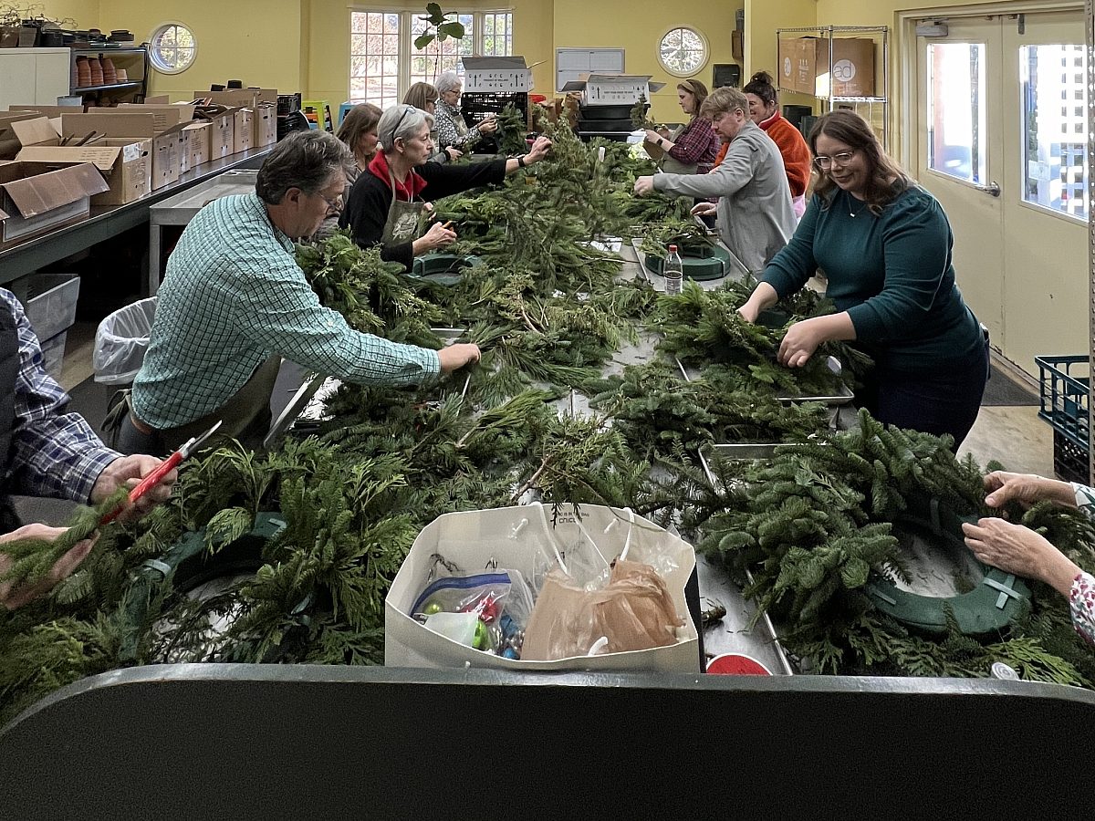 Workshop participants making holiday or winter Wreaths