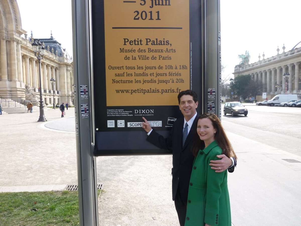 Kevin Sharp and Erin standing in front of a sign in Paris