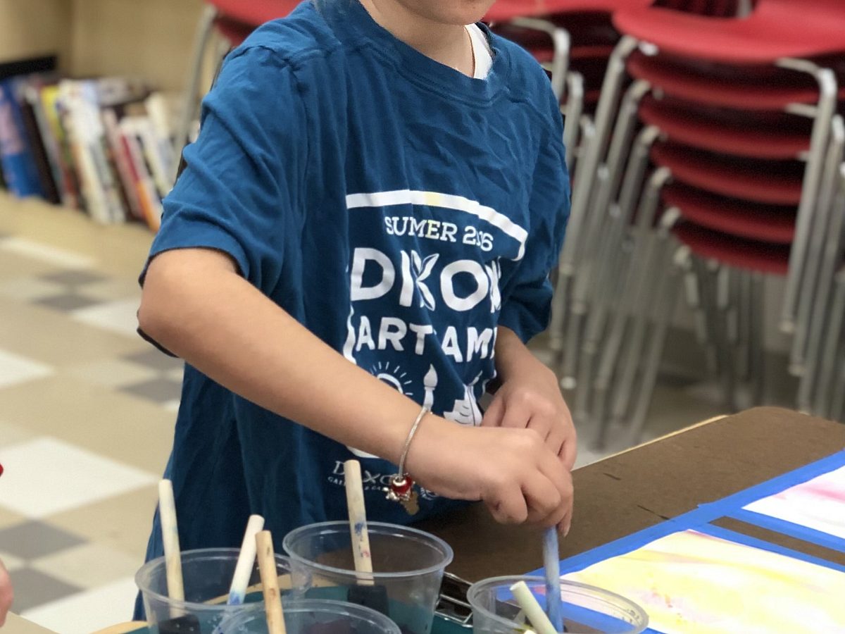 young child painting with water colors