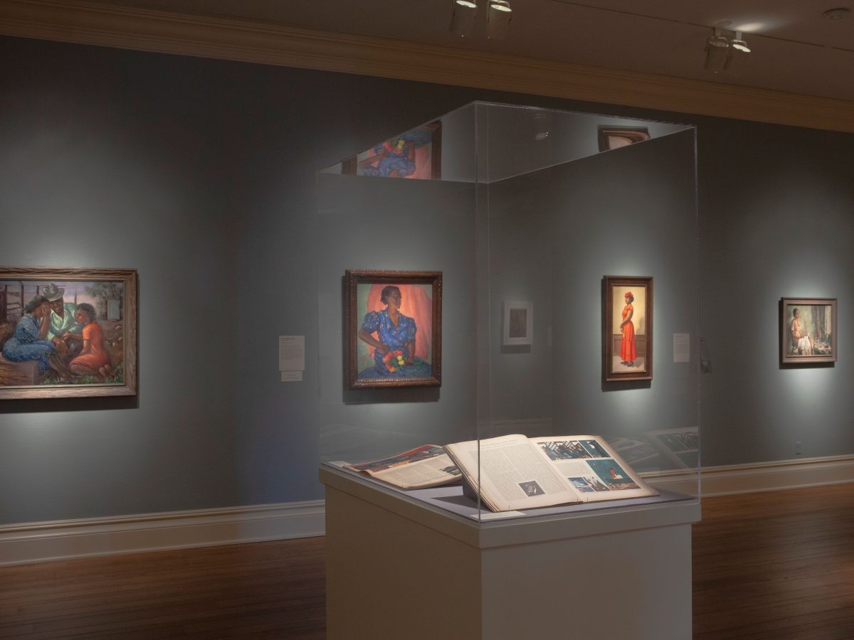 gallery of paintings and display case of books