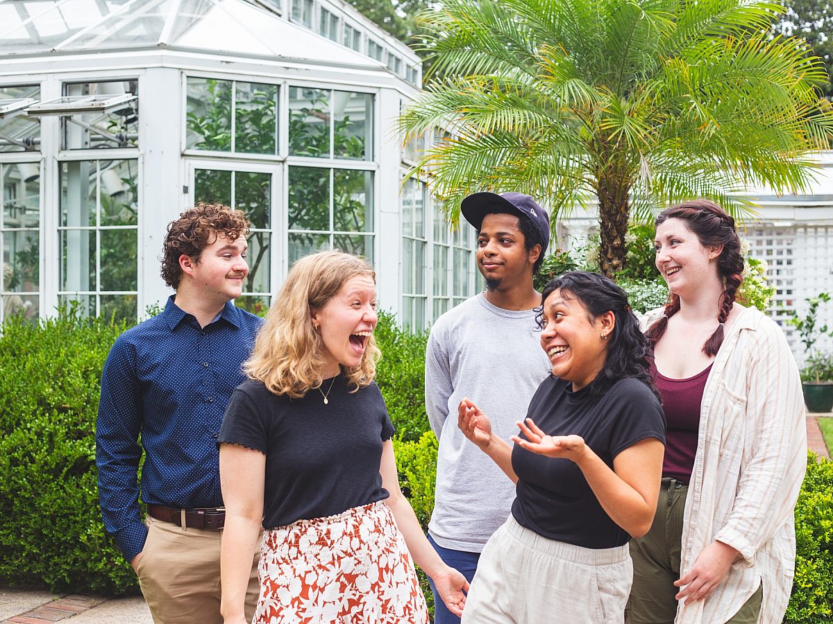 Interns-group-smiling headshots-garden-greenhouse