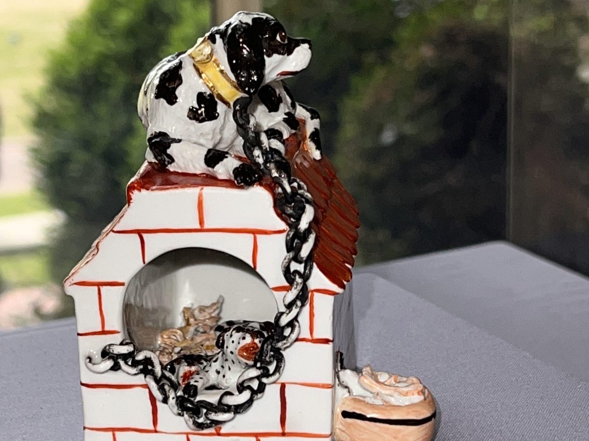 Kennel with Mother and Puppies with chain connected to kennel