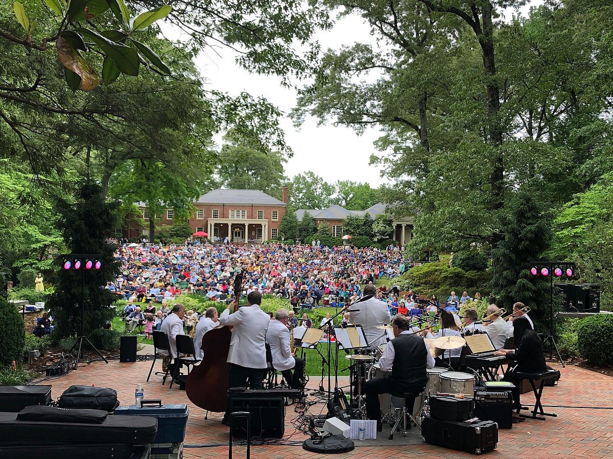 band on stage looking out over crowded lawn