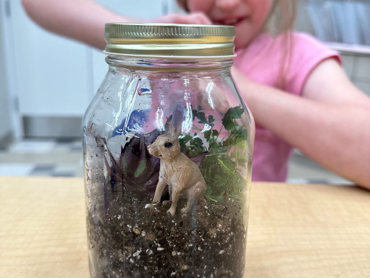 students behind craft in a jar
