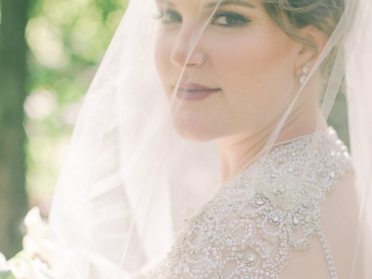 veiled bride looking over her shoulder at camera