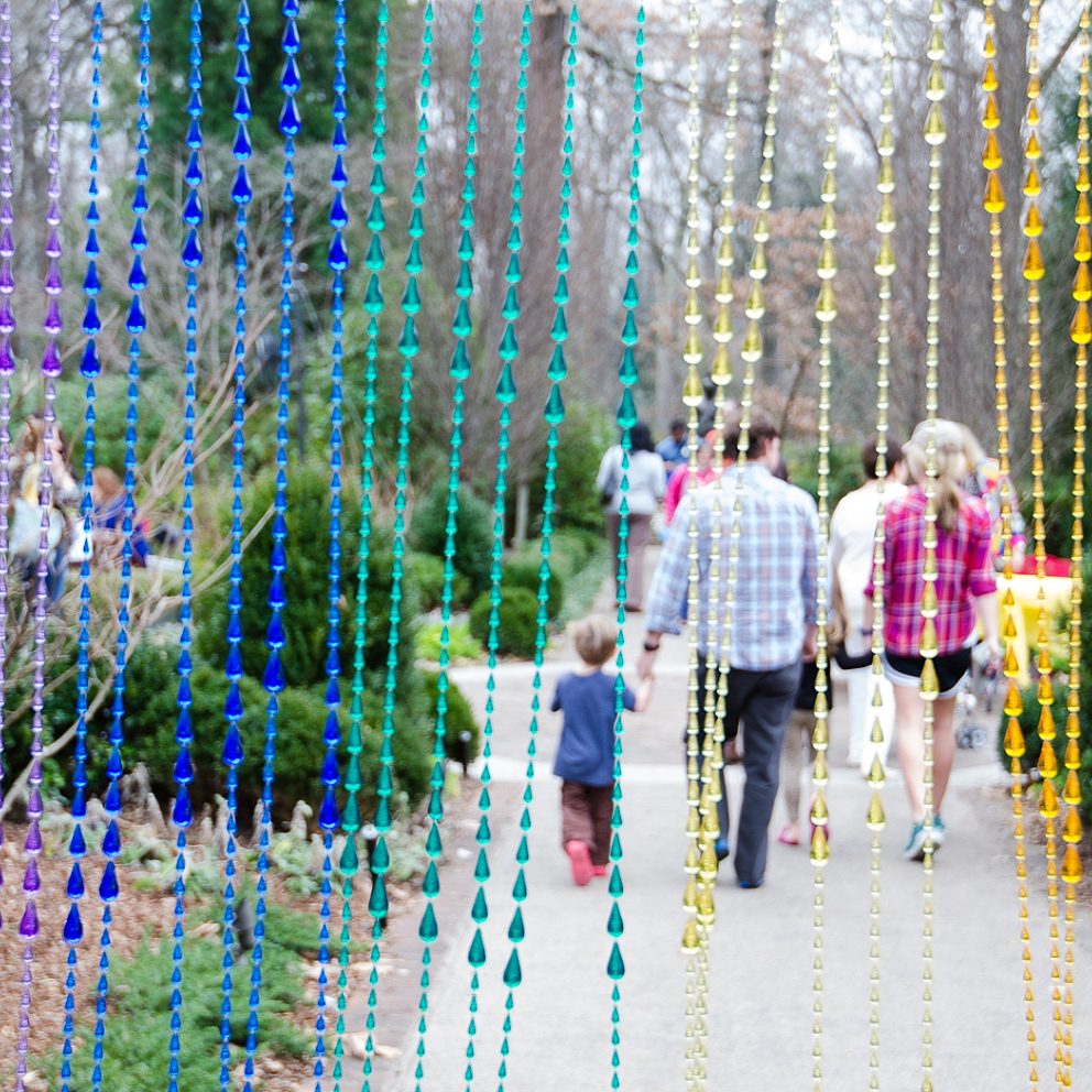 Family Day Beads- Admissions Booth Decorations, family walking toward the cutting garden after checking in
