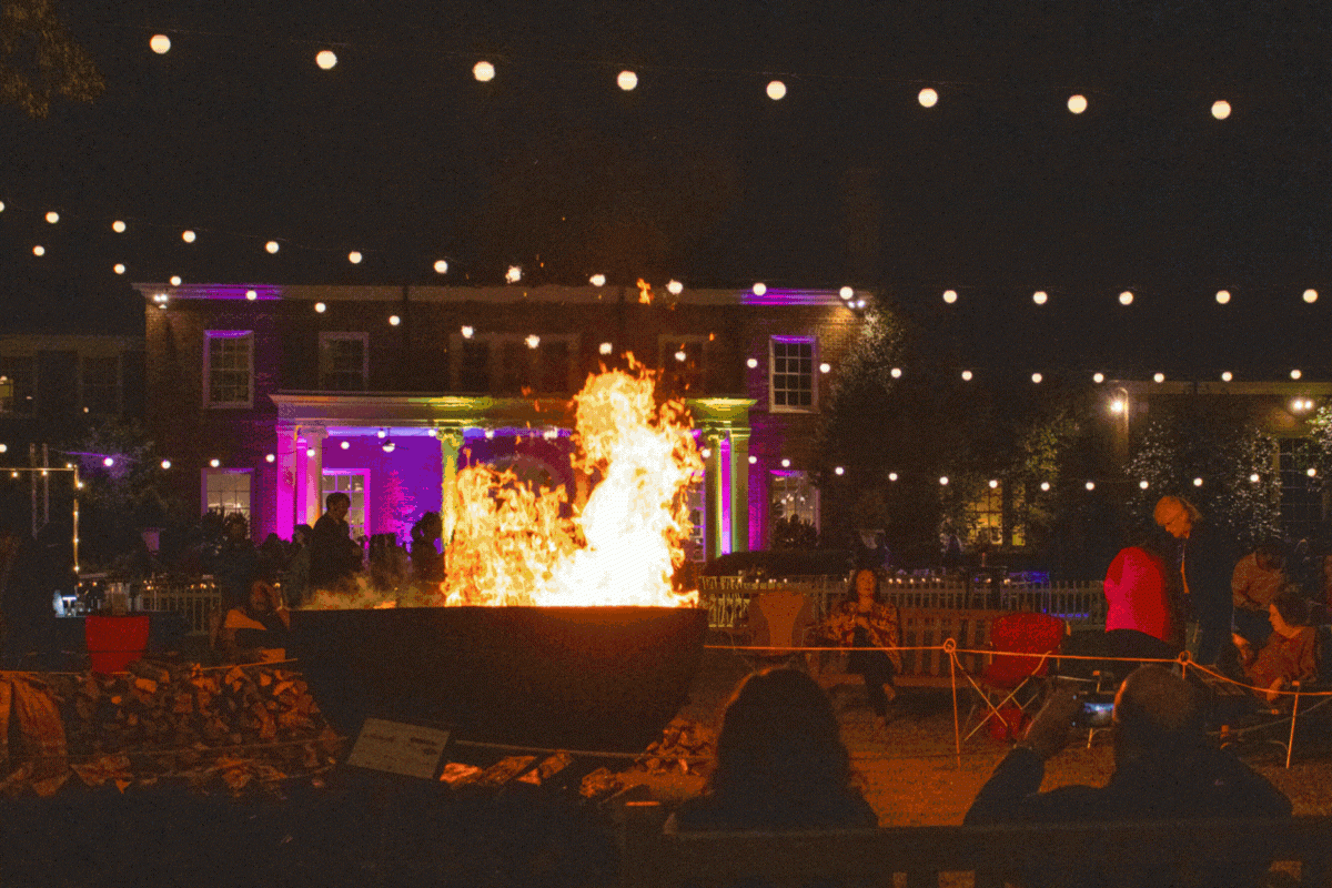 Art on fire celebration with string lights and fire in large cauldron on the south lawn